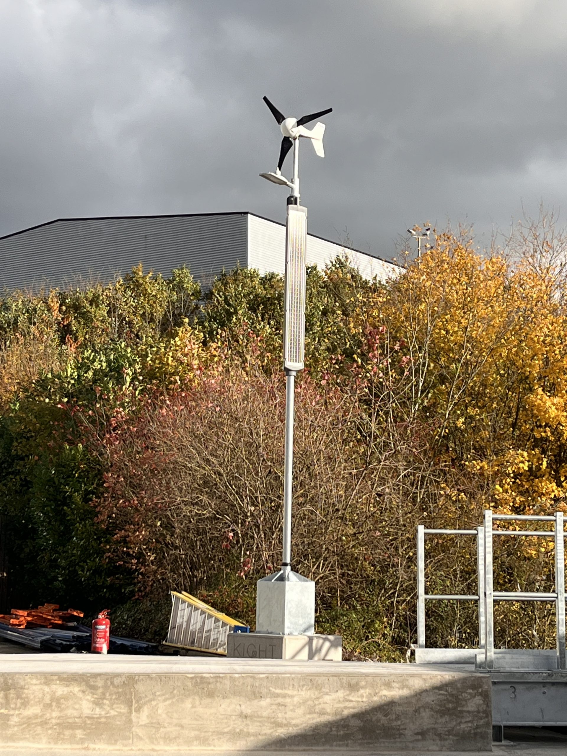 Portable off-grid lighting column with solar panels and wind turbine attached